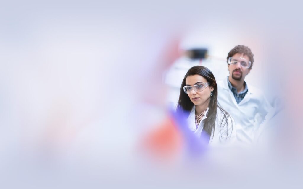 Two scientists observing experiment in laboratory