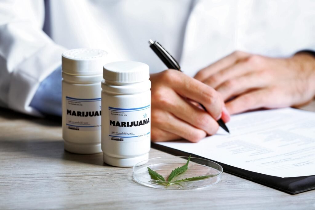 Medical marijuana bottles, cannabis leaf, doctor writing