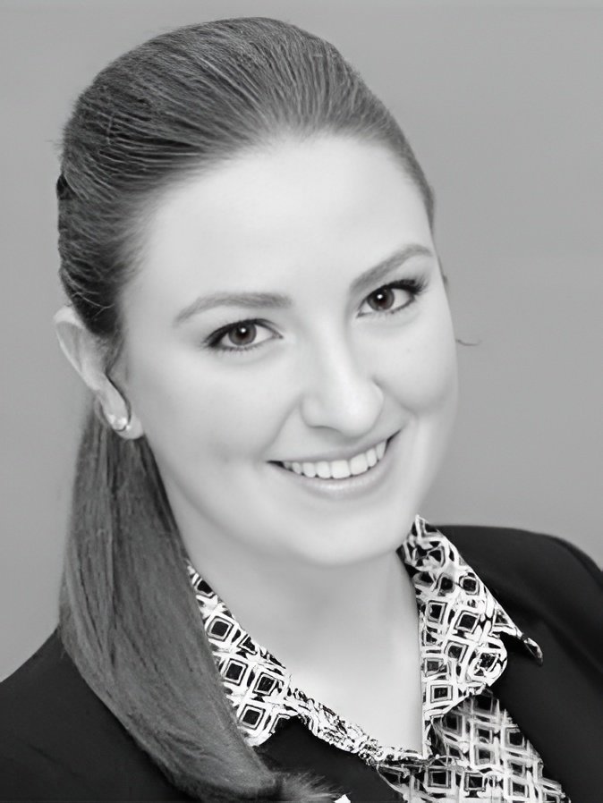 Professional headshot of smiling woman in business attire