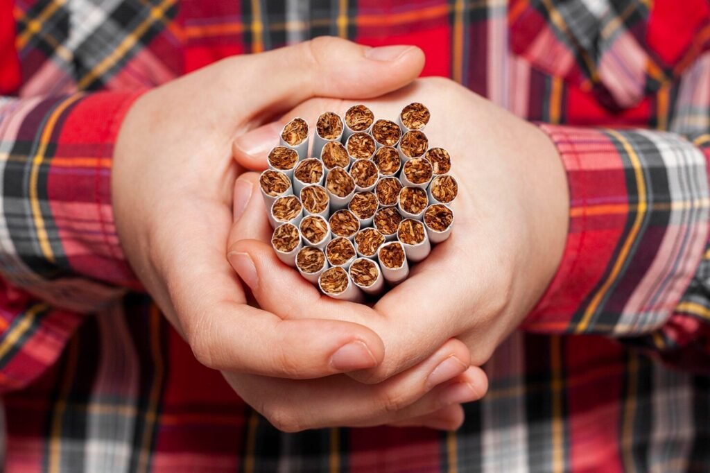 Hands holding bundle of cigarettes
