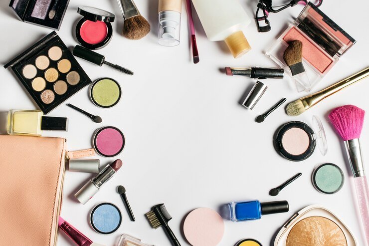 Assorted cosmetics and brushes on white background