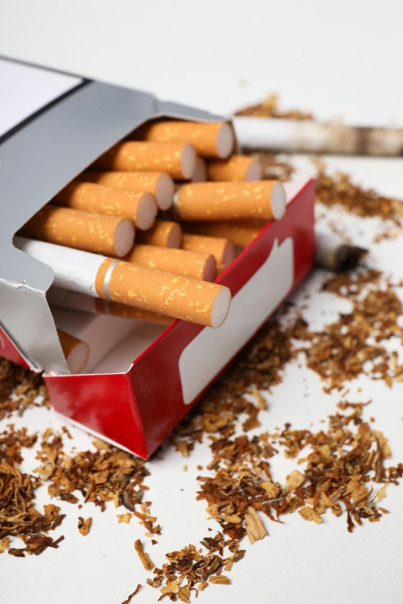 Open cigarette pack spilling loose tobacco