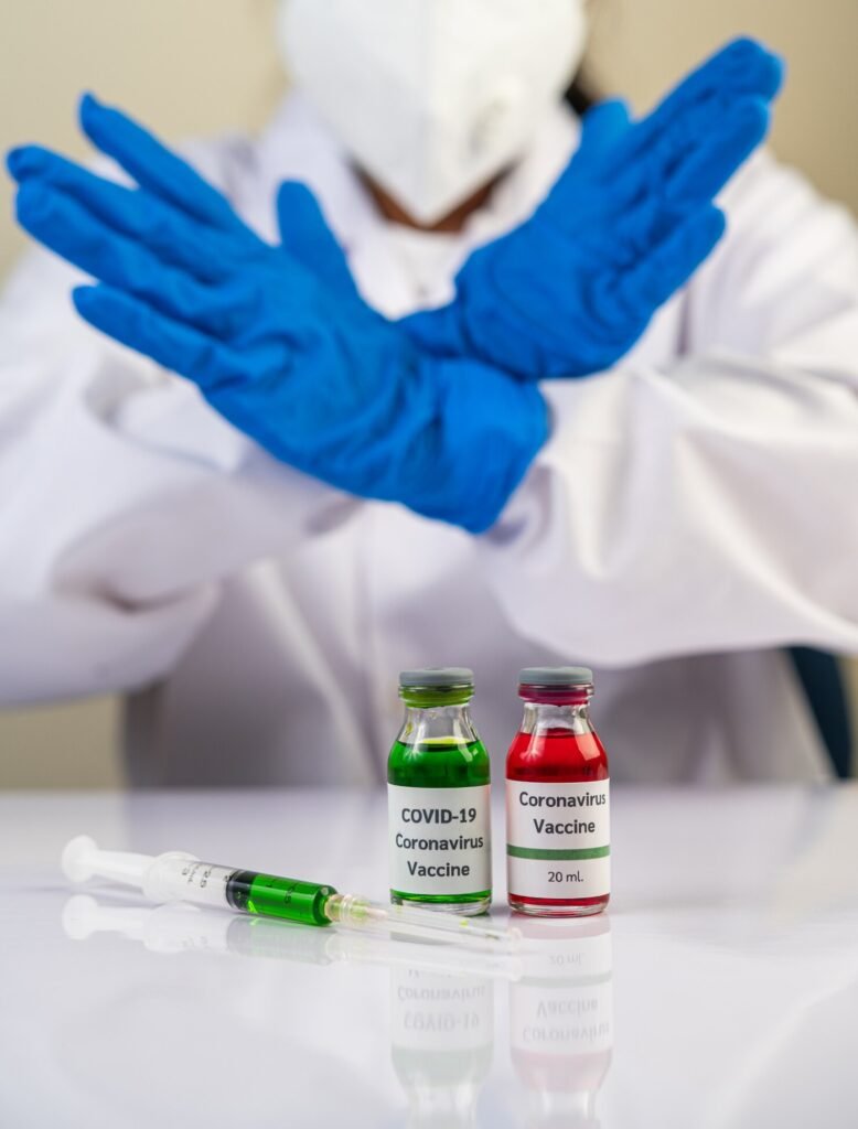 Gloved medical worker refusing COVID-19 vaccine vials