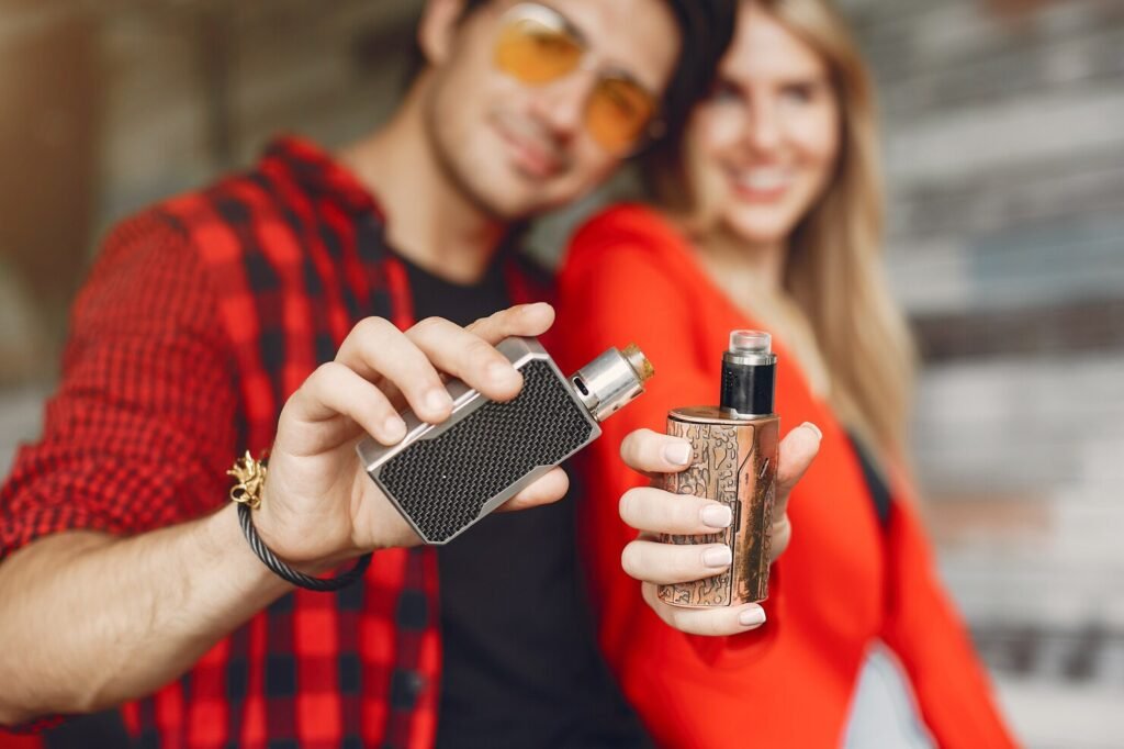 Couple holding vape devices