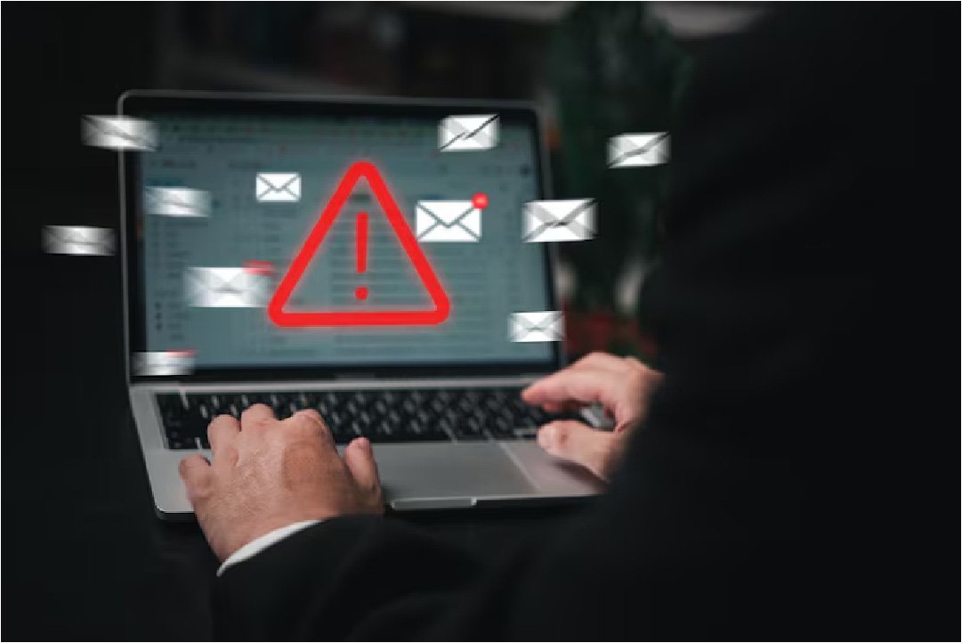 Laptop displaying phishing email warning